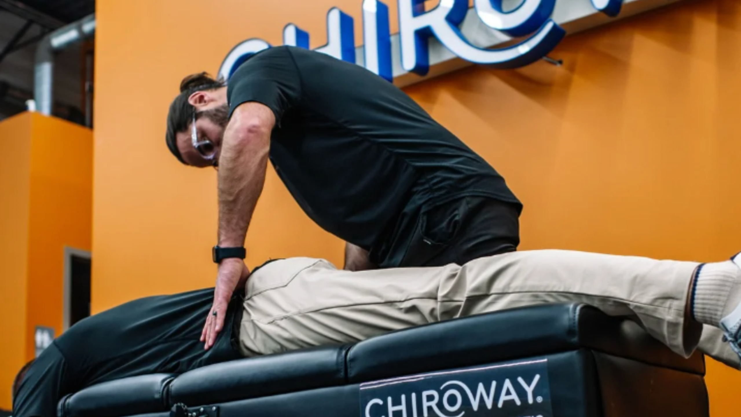Dr. Trent Scheidecker providing a chiropractic adjustment at a ChiroWay Center, representing hands-on care and a supportive franchise environment.
